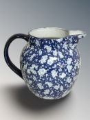 A Victoria Ware ironstone blue and white jug, height 26 cm.