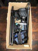 A group of camera bags and various tripods.