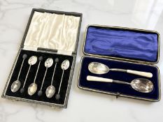 A cased set of six silver and enamel coffee spoons,