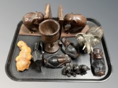 A group of African ebony ornaments, pair of elephant bookends, ceramic elephant, etc.