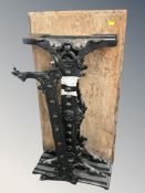A painted cast metal table base with wooden top.
