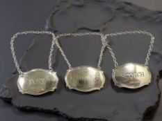 Three silver decanter labels - Scotch, Madeira and Port.