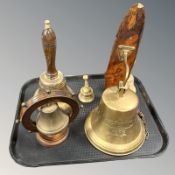 A replica Titanic 1912 brass ship's bell, on wooden wall bracket, and four further various bells.