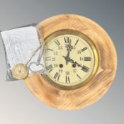 A pine circular wall clock, with twin barrel movement, striking on a gong, with pendulum and key,