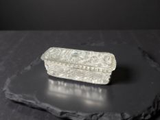 A cut crystal dressing table jar with silver embossed lid, Chester 1908, 9.5 cm x 4.5 cm.