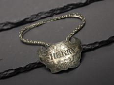A silver Sherry decanter label,