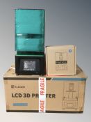 An Elegoo LCD 3D printer, and a toolkit with boxes.