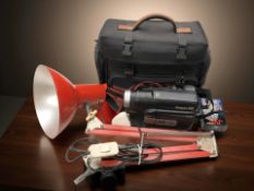 An enameled metal angle poised lamp, video camera.