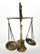 A small brass set of scales with weights, height 24 cm.