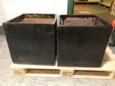 A pair of black glazed earthen ware square garden planters,