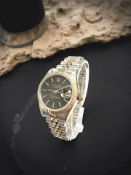 A lady's bi-metal Rolex Datejust wristwatch, model 69173, with black dial, case 25 mm.