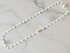 A pearl and turquoise necklace with 14ct gold spacers,