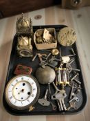 A group of clock parts, two lantern style clocks, keys, etc.