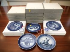 A group of Royal Copenhagen blue and white porcelain collector's plates in boxes.