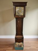 A George III oak eight day long case clock, with brass and silvered twelve inch dial,