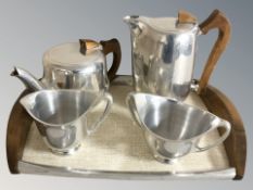 A four piece stainless steel Picquot Ware service on twin handled tray.