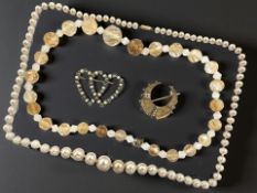 A 9ct yellow gold crescent shaped bar brooch mounted with seed pearls,