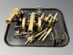 A group of brass and other metal miniature scale cannons on carriages.