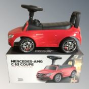 A child's ride-on Mercedes car with box.