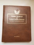 An album of golden replicas of United States stamps first day covers, layered in 22 carat gold.