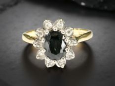 An 18ct yellow gold sapphire and diamond cluster ring. CONDITION REPORT: 4.3g.