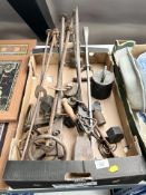 A group of cast iron balance scales and various weights.