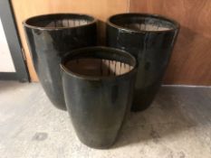 A pair of black glazed earthen ware garden planters,