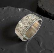 An antique silver cuff bracelet with engraved decoration.