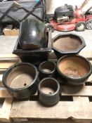 A group of black glazed earthen ware garden planters,