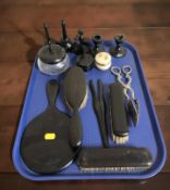 A group of ebony dressing table items, pair of EPNS tongs.
