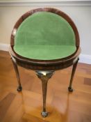 A mahogany demilune card table on claw and ball feet, width 80 cm.