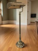 A brass and onyx standard lamp, height 130 cm.