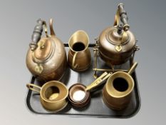 A group of copper and brass kettles, jugs, graduated miniature saucepans, etc.