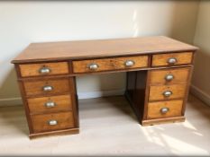 An Edwardian mahogany twin pedestal nine drawer desk, 151 cm x 64 cm x 77 cm.