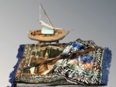 A scale model sailboat, length 63 cm, together with a carved wooden walking stick, blankets, etc.