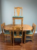 A modern pine extending dining table and set of four chairs, table 136 cm x 79 cm x 76 cm extended.