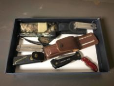 A group of folding multi-tools and knives, torch, etc.