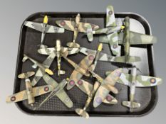 A group of die cast scale model WWII aircraft with stands.