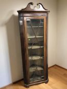 A 19th century mahogany glazed single door corner cabinet, with velvet lined interior,