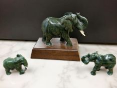 Three carved figures of elephants, in malachite or similar hard stone, tallest 13cm.