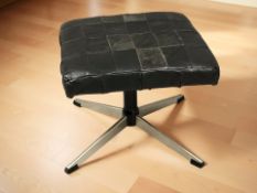 A Scandinavian black stitched leather and metal footstool.