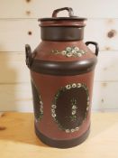 A painted metal milk churn, height 65 cm.