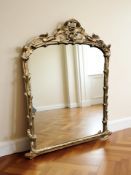 A late Victorian gilt gesso over mantel mirror, 154 cm x 130 cm.