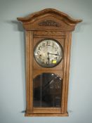 An early 20th century oak eight day wall clock,