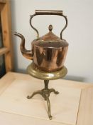 A Victorian copper kettle and a brass kettle stand.