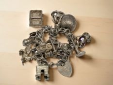 A silver charm bracelet. CONDITION REPORT: 56.9g.