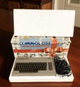 A Commodore 64 computer compendium, in box.