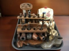 Three pipe racks containing assorted pipes, two brass desk punchers, miniature keg and mugs, etc.