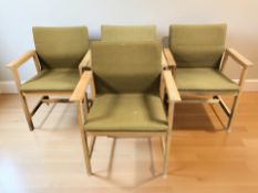 A set of four Danish oak framed armchairs in olive fabric.