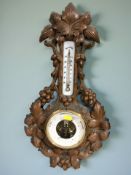 A Danish heavily carved beech barometer / thermometer, height 56 cm.